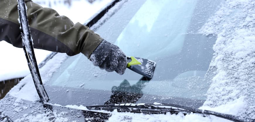 scapping windscreen from ice in the winter